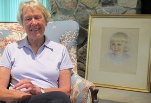 Kitty Crosby at home with her Helen Baxter portrait.