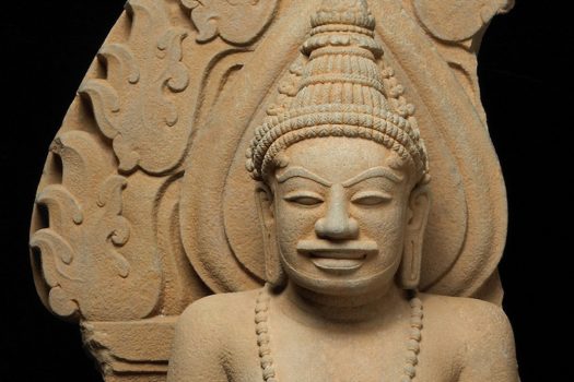 A Vietnamese, sandstone sculpture depicting a deified king.