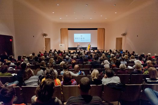 guests seated in an auditorium listening to a lecture