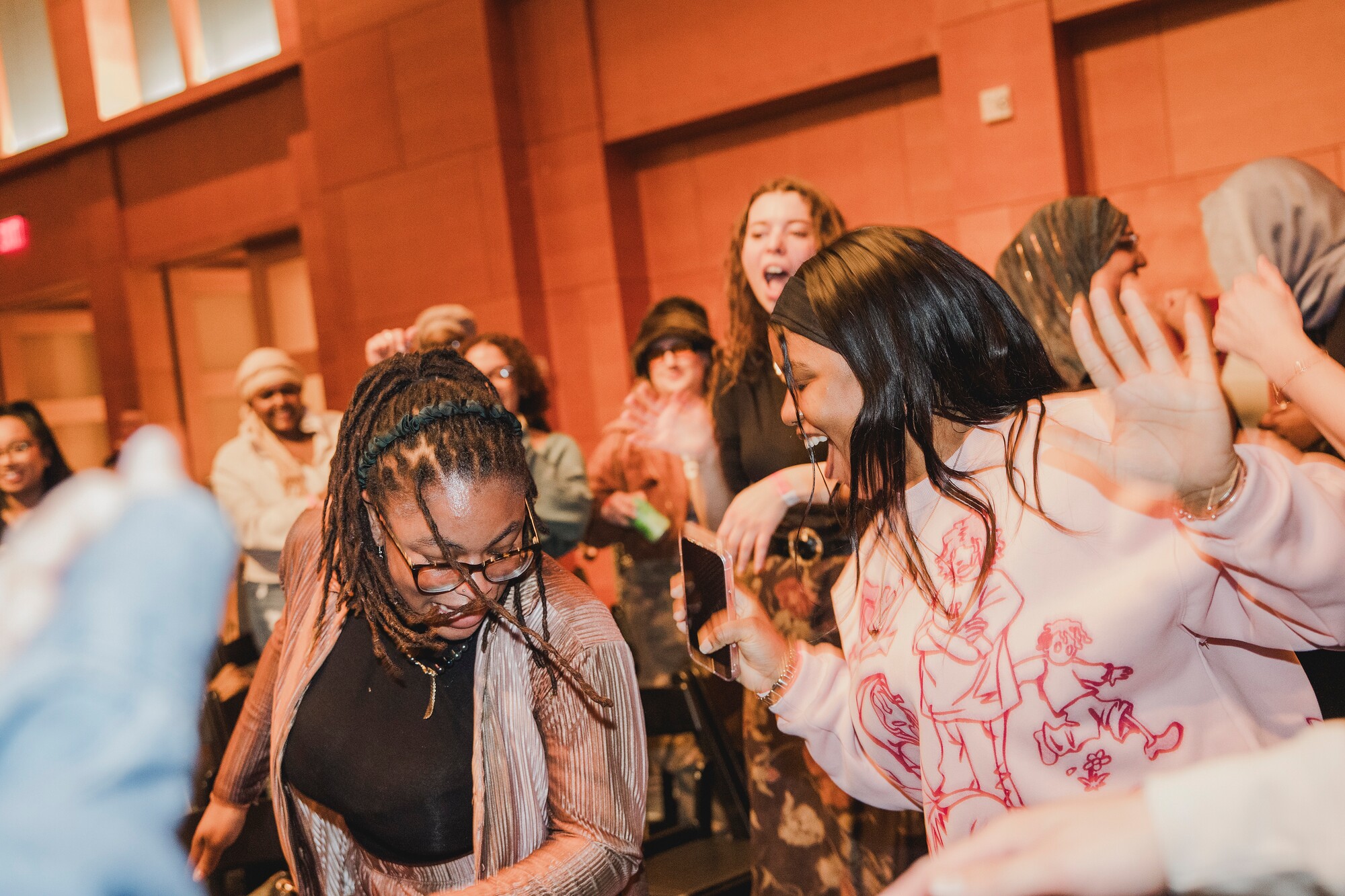 photo of people smiling and dancing at Mia