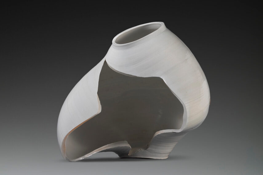 abstract sculpture of a large white jar, with a large hole in the side