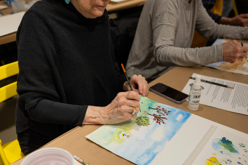 A Vitality Arts workshop participant paints a watercolor painting