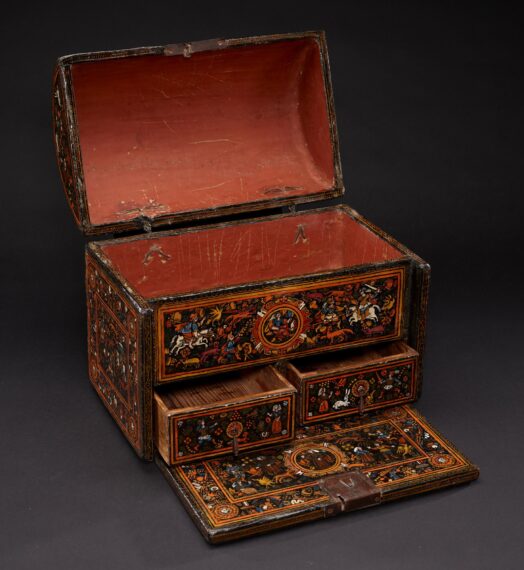 The bufetillo with the lid open, two bottom drawers slightly opened and the writing surface at the base pulled out