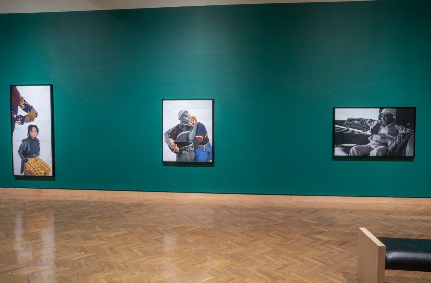 Photo of three artworks on a gallery wall