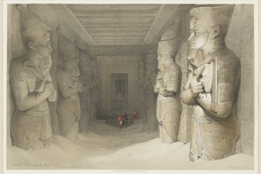 view into an Egyptian temple hall lined with colossal carved statues of pharaohs, buried up the knees in sand, with a small group of men in Arab dress gathered at the center of the hall