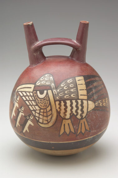 Red pot shaped like a kettle bell with a bird-like figure painted on it