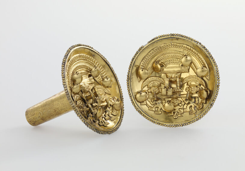 photo of a pair of ancient gold earrings, flat circles with engravings