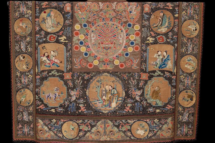 Intricate tapestry with various circular and rectangular scenes.