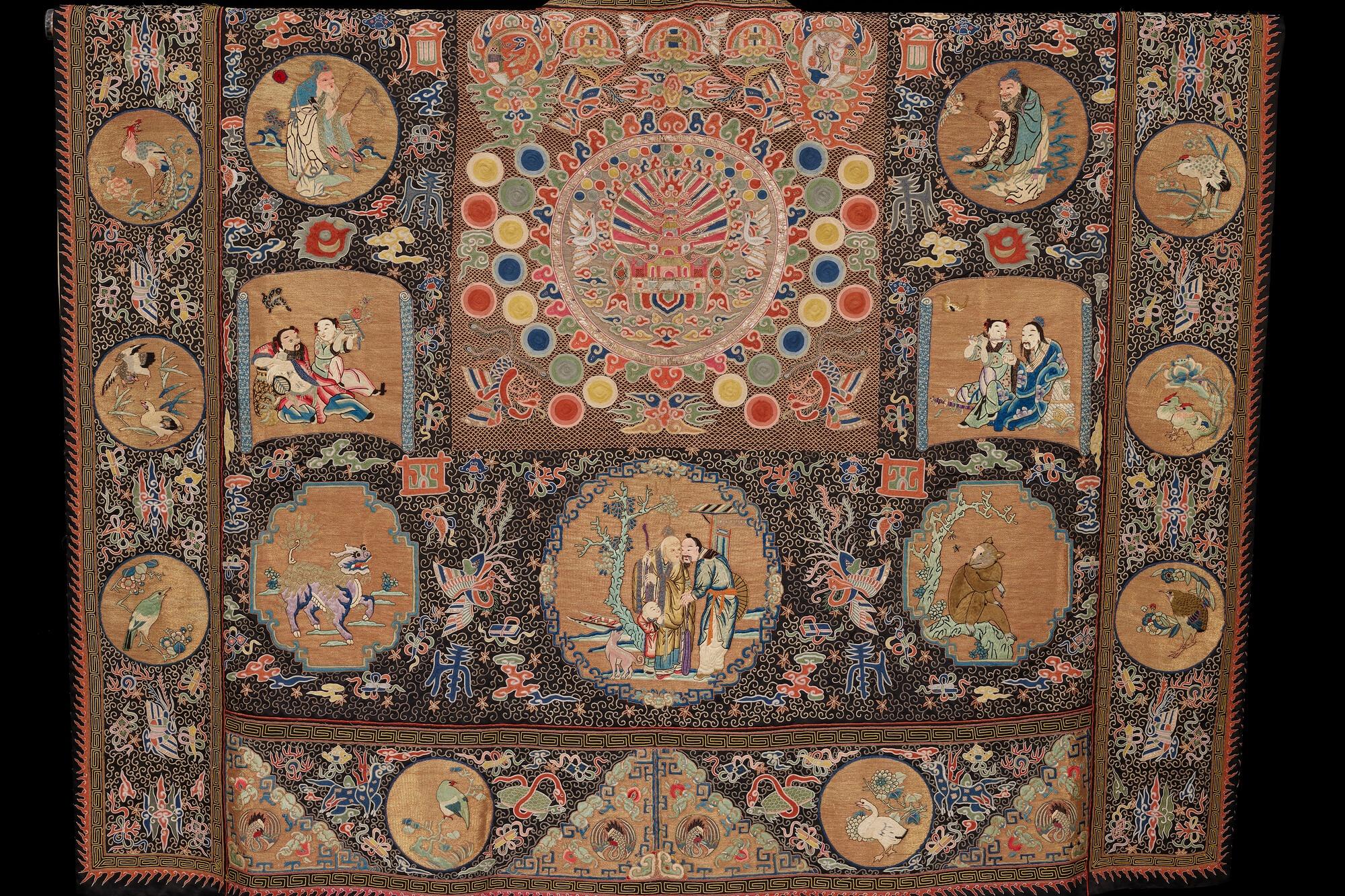 Intricate tapestry with various circular and rectangular scenes.
