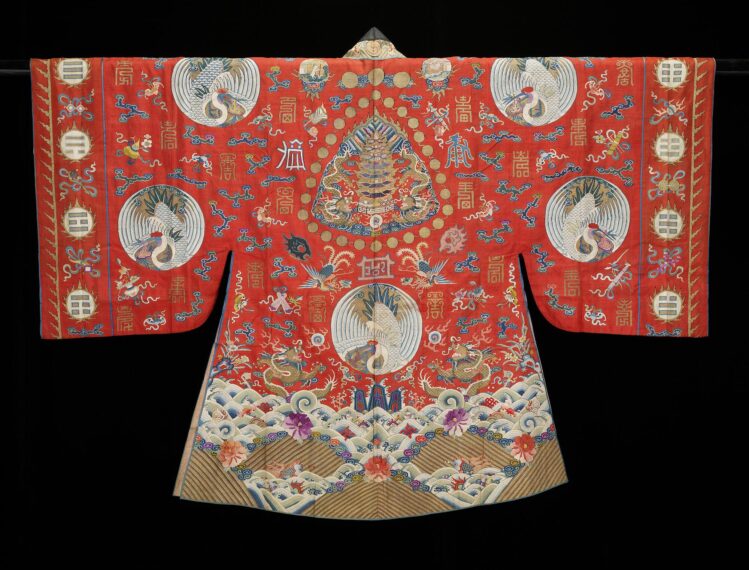 Intricately designed red robe with circular patterns and floral designs