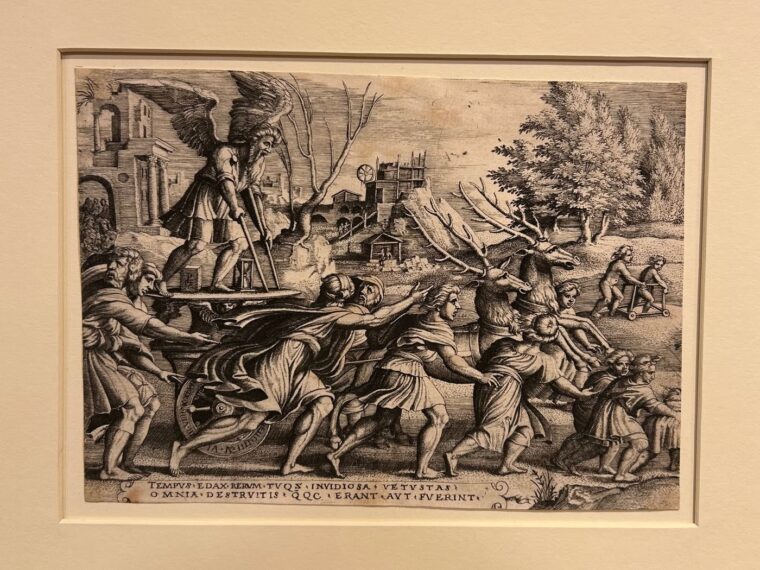 Detailed black-and-white illustration depicting a historical scene. Central to the artwork is a large, winged figure standing on a platform, holding two staffs. This figure is elevated above a group of people who appear to be pulling the platform along. These individuals are dressed in flowing robes, and their expressions are intense with action. In front of the platform, two large animals with long antlers are being guided by additional figures.