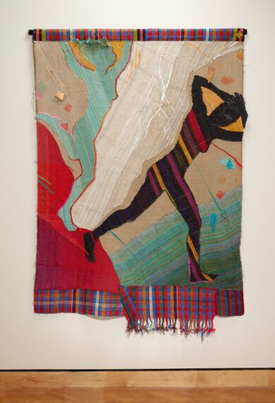 Tapestry with abstract colorful design and a figure in motion.