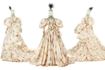 Vintage floral gown with puffed sleeves on a mannequin.