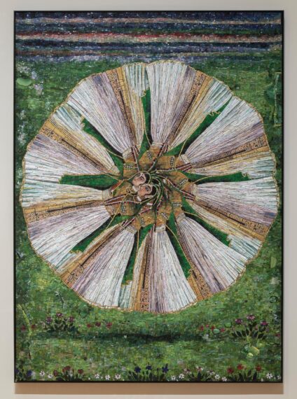 Mosaic of a circular design with fan-like patterns on green background.