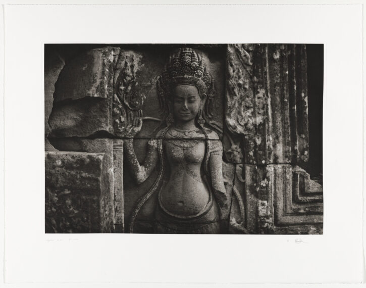 Stone carving of a figure on an ancient temple wall.