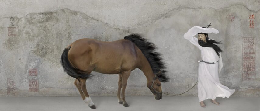 A man dressed in flowing white robes and a black belt, holding a black hat or hood over his head. Beside him is a brown horse with a dark mane and white markings on its legs.
