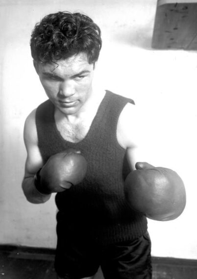 black-and-white photo of Max Schmeling wearing a tank top and boxing gloves