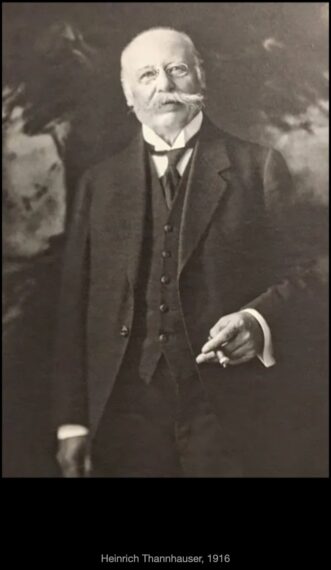 black-and-white photograph of an older man wearing a three-piece suit and holding a cigar
