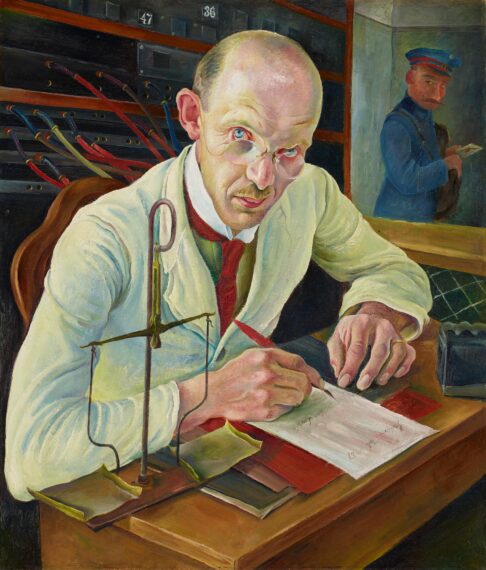 The image depicts a man sitting at a wooden desk, wearing a white coat, glasses, and a red tie. He is focused on writing with a red pen on a piece of paper. In the background, there is an employee in a blue uniform, cap, and red armband, visible behind a glass partition.
