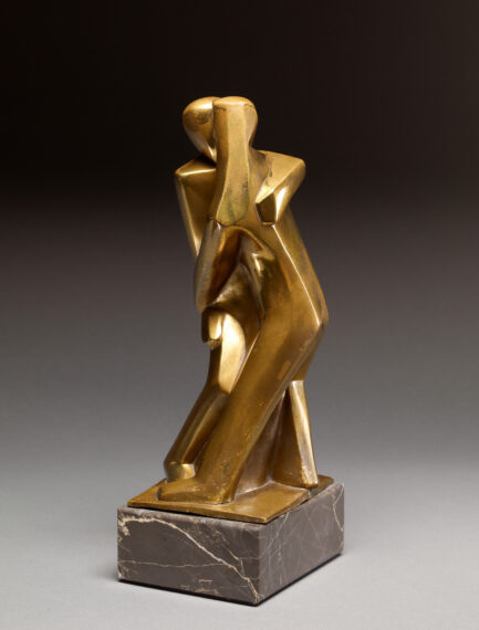 Abstract bronze sculpture of two embracing figures on a marble base.