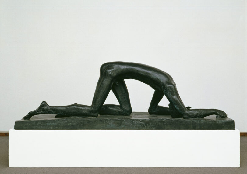 Bronze sculpture of a figure on hands and knees.