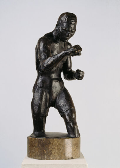 Bronze statue of a boxer in a fighting stance.