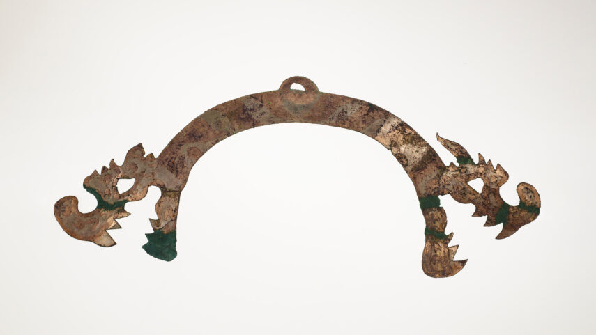 Ornate, arched metal object with dragon motifs.