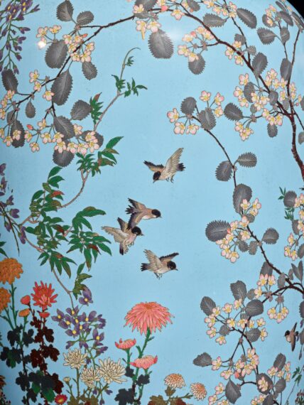 Decorative scene with birds, flowers, and branches on a light blue background.