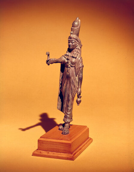 Bronze statue of a figure in ancient attire on a wooden base.