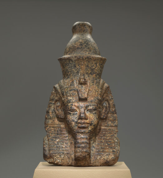 Stone bust of an ancient Egyptian person with headdress
