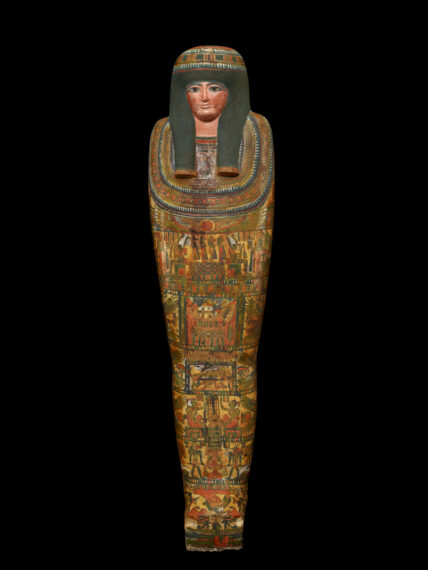 Decorated ancient Egyptian sarcophagus on a black background.