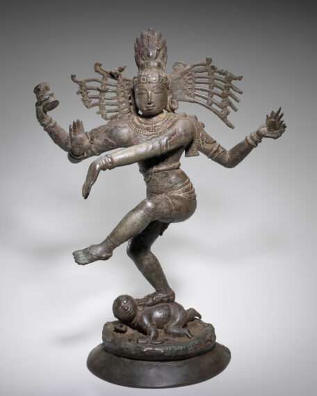 Bronze statue of a multi-armed figure in a dynamic pose.