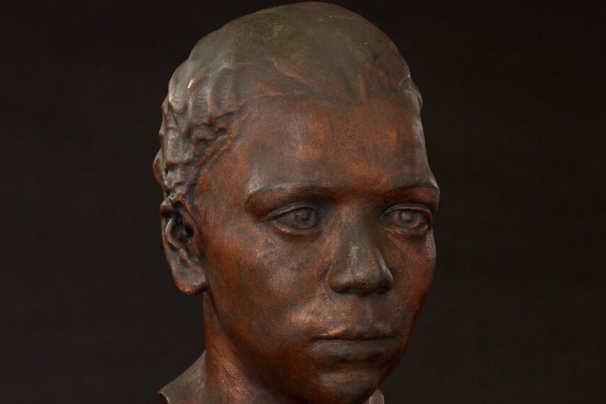 Bronze sculpture of a young person's head.