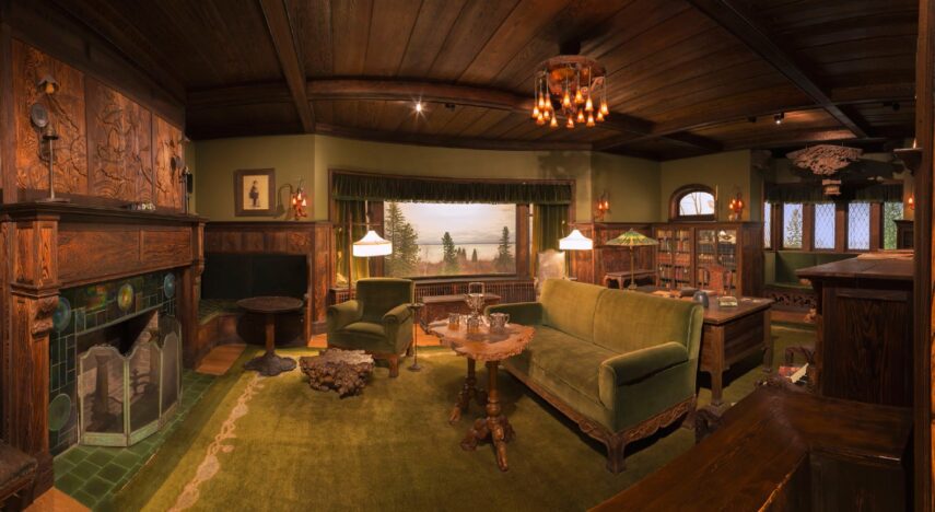 Cozy living room with wooden decor and green furniture.