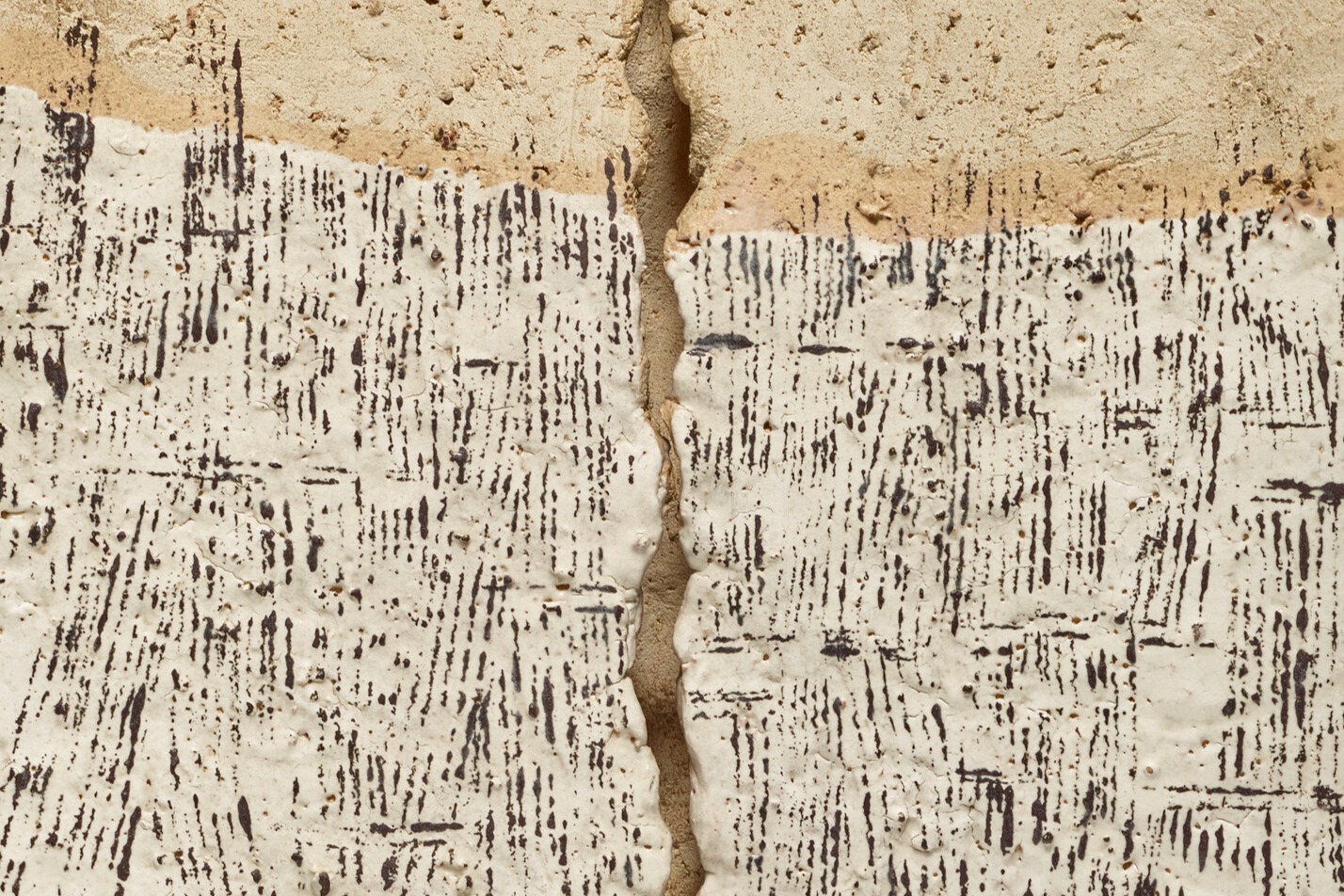 Cracked ceramic with textured pattern and straight lines.