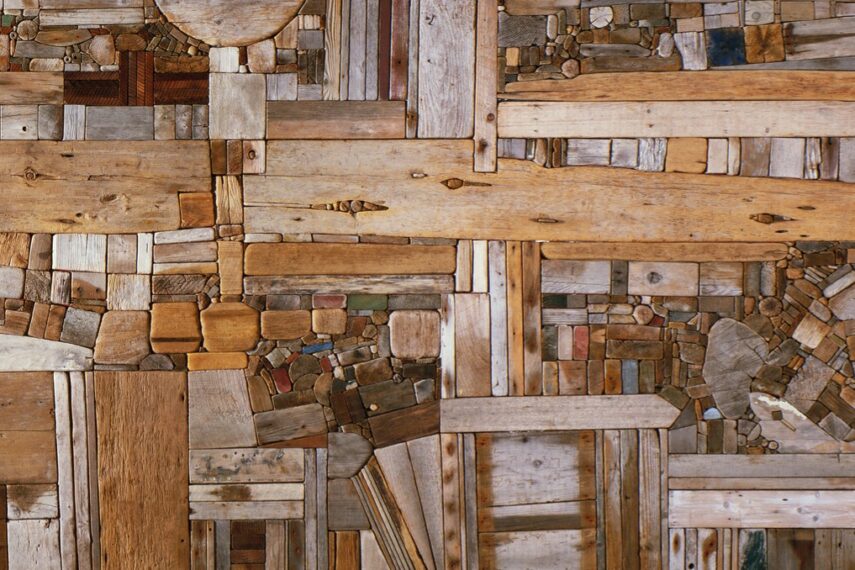 Abstract artwork of wooden pieces arranged in a collage.