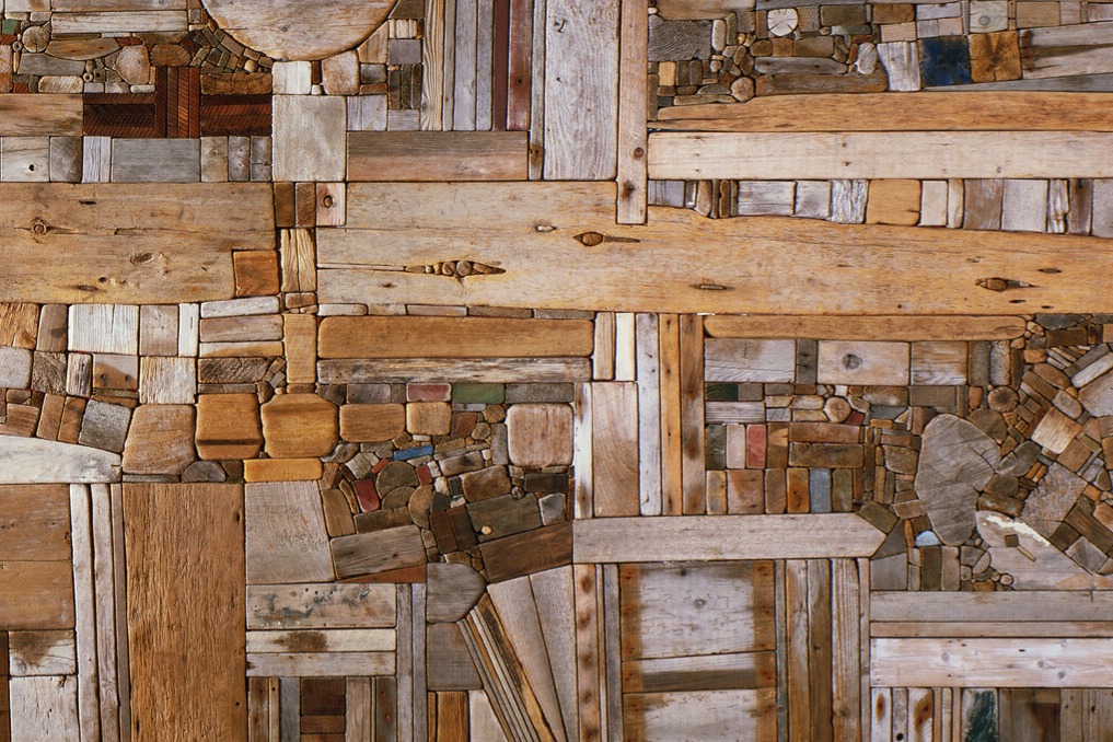 Abstract artwork of wooden pieces arranged in a collage.
