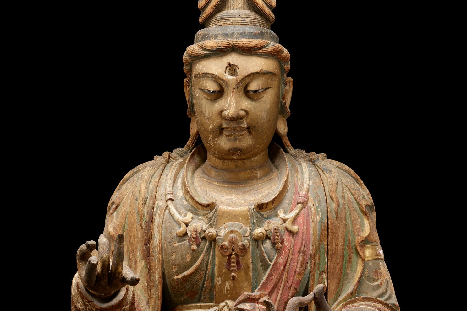 Statue of seated Bodhisattva Guanyin with intricate details.