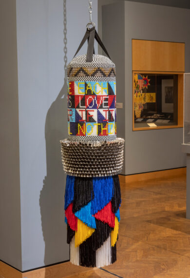 Decorative punching bag with colorful beaded patterns.