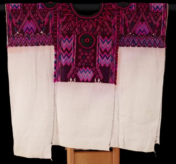 Intricately patterned textile with bright colors and geometric designs.