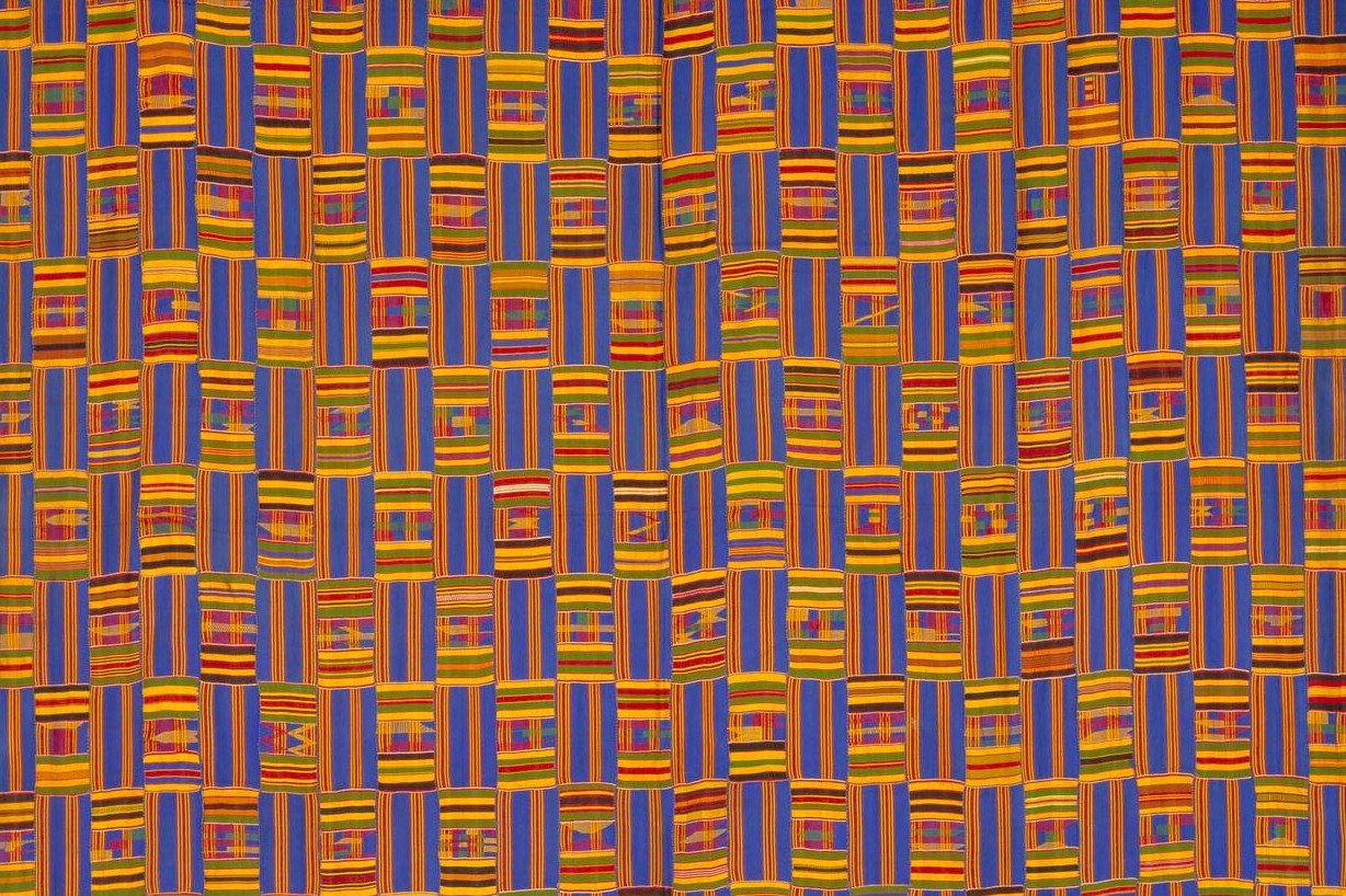 Colorful textile with geometric patterns in orange, blue, and yellow.