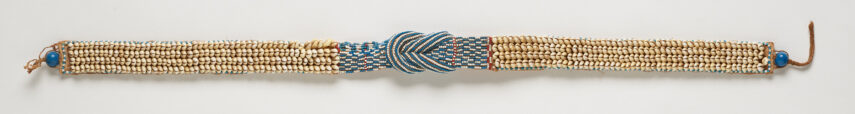 Beaded bracelet with blue and beige beads in a woven pattern.