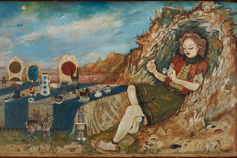 The image shows a person reclining near a decorated table in a rocky landscape. They are wearing a red and green outfit with intricate patterns and are holding small objects in their hands. In front of them, there is a table draped in a richly decorated cloth, featuring an array of ornamental items. A small tiger-striped cat stands next to the table. The background depicts an expansive landscape with rolling hills and a cloudy sky.