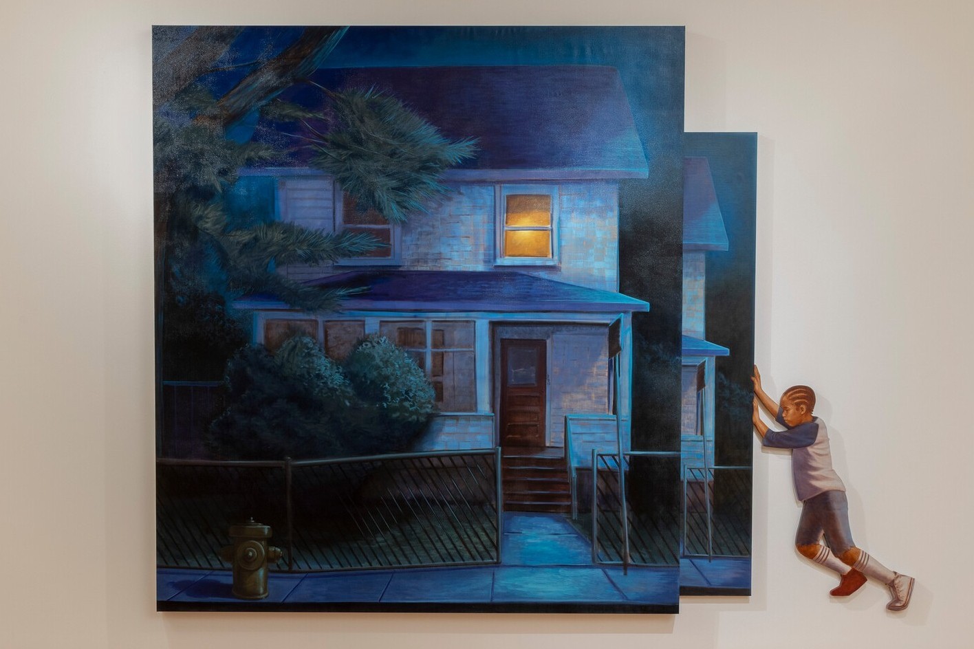Large painting of a house with a figure of a child pushing on its edge.