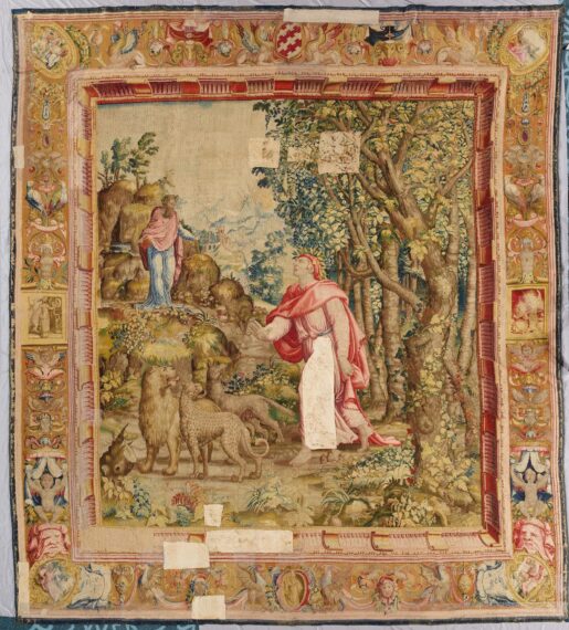 Reverse view of a decorative tapestry with figures, animals, and detailed border.
