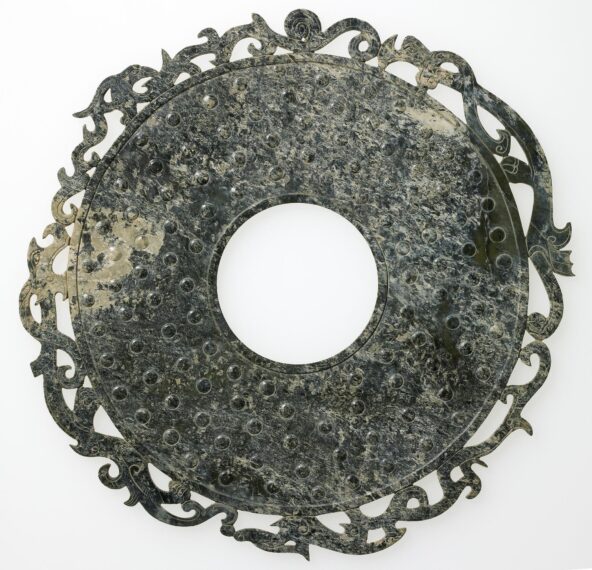 Ornate round object with intricate patterns and a central hole