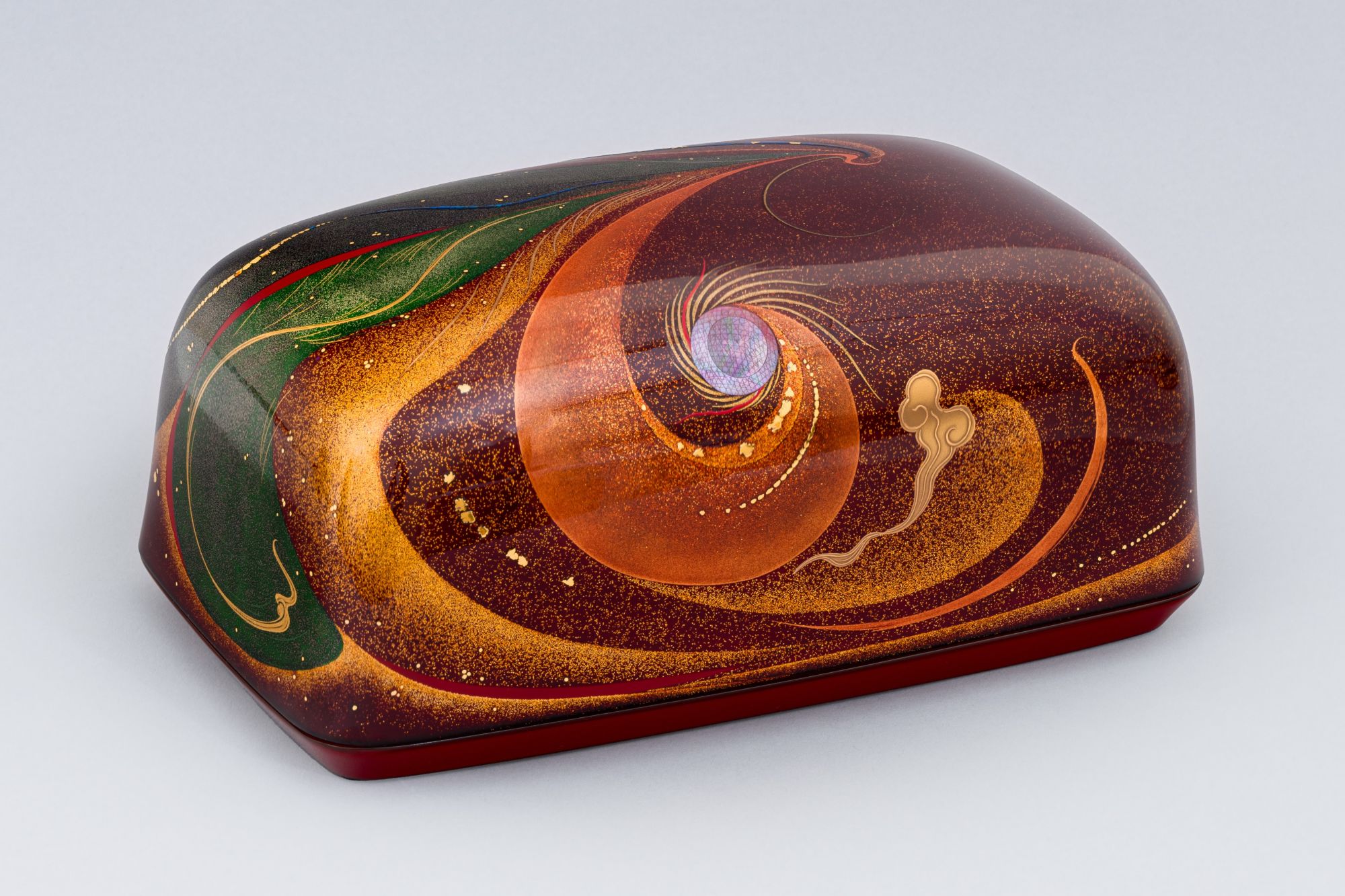 Decorative rectangular lacquer box with swirling orange design.