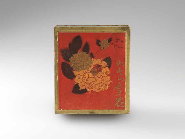 Red box with floral and text design on the front.