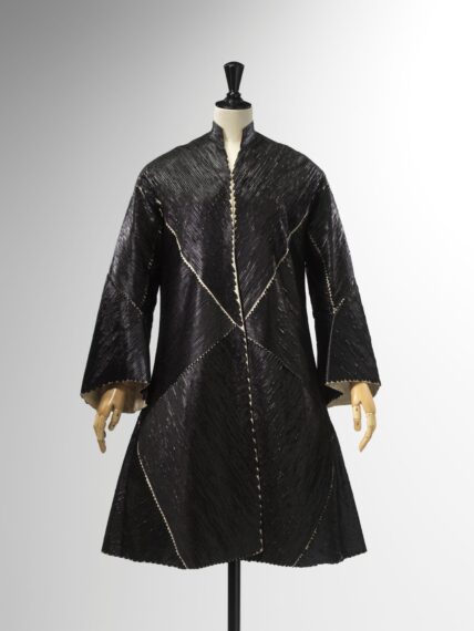 The image shows a black coat displayed on a mannequin.