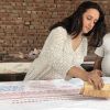 Artist Hemangini Rathore creating a block print on textile.